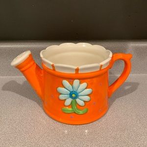 Orange ceramic watering can